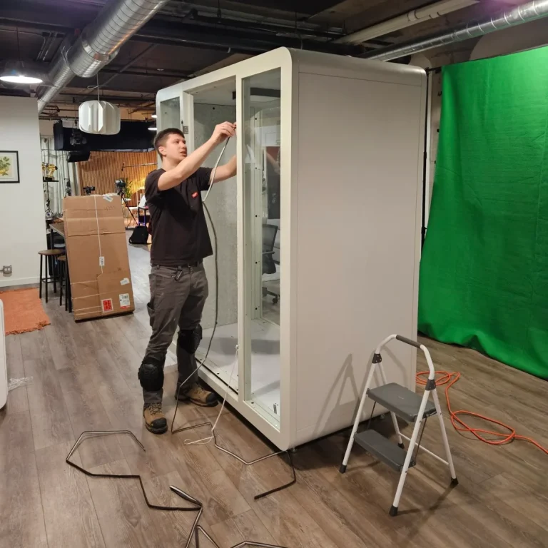 The master assembles a large transparent cabinet
