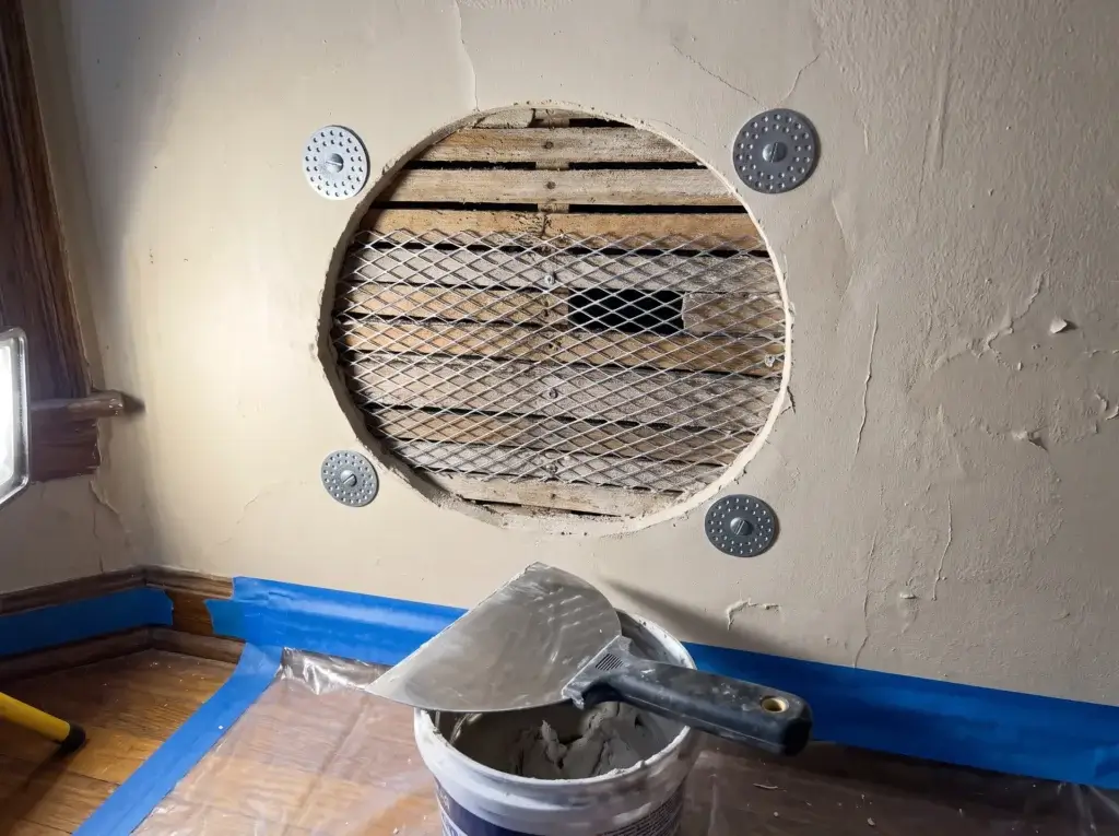 Galvanized metal lath and plaster washers over wood lath before the first coat of setting compound - plaster and lath repair